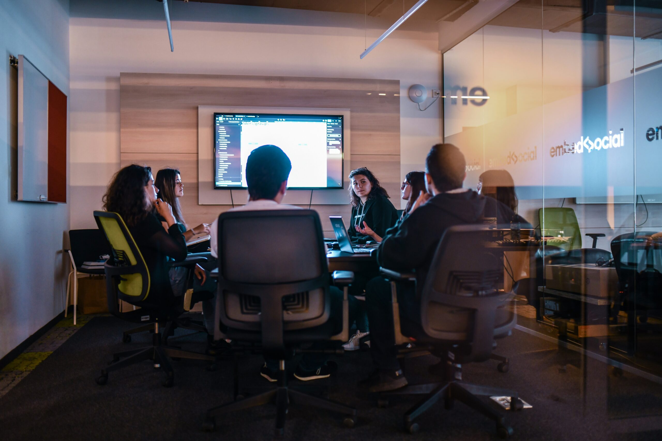 Manufacturing executives reconciling conflicting reports before a board meeting Two manufacturing company leaders sit at a table comparing printed reports side by side, representing the common pre-meeting scramble to reconcile numbers that don't match across systems.