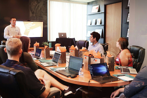 Manufacturing company leadership team in a strategy meeting A small group of manufacturing company executives sit around a table reviewing charts and reports, representing a leadership team trying to diagnose why growth has stalled despite multiple past fixes.